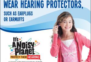A young girl putting earplugs in her ears.