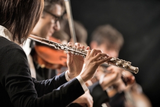 Female flutist performing, hands close-up