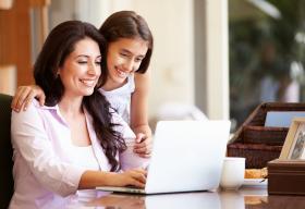 Woman and child looking at a laptop.